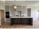 Charming kitchen with large center island, modern pendant lighting, and stainless steel appliances at 25 Deer Tail Ln # 52, Fuquay Varina, NC 27526