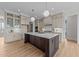 Spacious kitchen features an island, hardwood floors, modern appliances and pendant lighting at 25 Deer Tail Ln # 52, Fuquay Varina, NC 27526