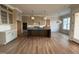 Open kitchen with hardwood floors, custom cabinets, central island and modern appliances in a new construction home at 25 Deer Tail Ln # 52, Fuquay Varina, NC 27526