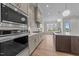 Gourmet kitchen with stainless steel appliances, custom cabinets, and modern lighting at 25 Deer Tail Ln # 52, Fuquay Varina, NC 27526
