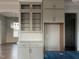 Kitchen with custom cabinets with glass fronts, white countertops, and stainless steel appliances at 25 Deer Tail Ln # 52, Fuquay Varina, NC 27526
