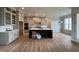Open kitchen featuring a large center island with dark cabinets and modern pendant lighting at 25 Deer Tail Ln # 52, Fuquay Varina, NC 27526