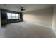 A large, bright room includes recessed lighting, a ceiling fan, and built-in bookshelves at 25 Deer Tail Ln # 52, Fuquay Varina, NC 27526