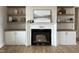 Cozy living room featuring a fireplace flanked by custom built-in shelving and cabinetry at 25 Deer Tail Ln # 52, Fuquay Varina, NC 27526