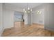 Spacious living room with hardwood floors, modern lighting, and open access to the kitchen and dining areas at 25 Deer Tail Ln # 52, Fuquay Varina, NC 27526
