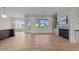 Open-concept living room with hardwood floors, a fireplace, and lots of natural light from large windows at 25 Deer Tail Ln # 52, Fuquay Varina, NC 27526