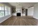 Spacious living room boasts fireplace with mantel, built-in shelving, and large windows overlooking front yard at 25 Deer Tail Ln # 52, Fuquay Varina, NC 27526