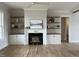 Living room featuring hardwood floors, fireplace, and built-in shelving at 25 Deer Tail Ln # 52, Fuquay Varina, NC 27526
