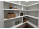 Organized walk-in pantry with ample shelving for storing food items and kitchen essentials at 25 Deer Tail Ln # 52, Fuquay Varina, NC 27526