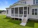 Exterior view of screened porch with white railing and steps leading to yard at 25 Deer Tail Ln # 52, Fuquay Varina, NC 27526