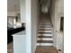 Bright staircase features hardwood treads, white risers, and a wooden handrail, adding modern charm to the home's interior at 25 Deer Tail Ln # 52, Fuquay Varina, NC 27526