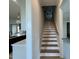 Staircase featuring a light wood banister and white risers, connects multiple levels of the home at 25 Deer Tail Ln # 52, Fuquay Varina, NC 27526