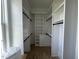 Bright walk-in closet with built-in shelving, hanging rods and wood floors at 25 Deer Tail Ln # 52, Fuquay Varina, NC 27526