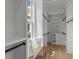 Bright walk-in closet with custom shelving, natural light, and hardwood flooring at 25 Deer Tail Ln # 52, Fuquay Varina, NC 27526