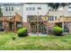 View of the back of the house with multiple patios and green grass at 2506 Blooming St, Raleigh, NC 27612