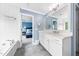 Spacious bathroom with a soaking tub, white vanity, and tile flooring at 2506 Blooming St, Raleigh, NC 27612