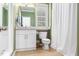 Bathroom featuring white cabinets, a marble countertop, and a tiled floor at 2506 Blooming St, Raleigh, NC 27612