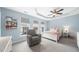 Bedroom with tray ceiling, three windows and light blue paint at 2506 Blooming St, Raleigh, NC 27612