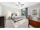 Bedroom with a ceiling fan, a work desk, and teal curtains at 2506 Blooming St, Raleigh, NC 27612
