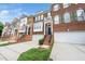 Charming townhomes featuring brick facades, manicured lawns and two-car garages at 2506 Blooming St, Raleigh, NC 27612