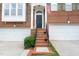 Welcoming front entrance with brick steps, black door, and neat landscaping at 2506 Blooming St, Raleigh, NC 27612
