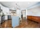 Bright kitchen with white cabinets, stainless steel appliances, and a center island at 2506 Blooming St, Raleigh, NC 27612