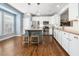 Bright kitchen with white cabinets, stainless steel appliances, and a center island at 2506 Blooming St, Raleigh, NC 27612