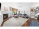 Inviting living room with a fireplace, large windows, and comfortable seating at 2506 Blooming St, Raleigh, NC 27612