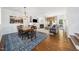Cozy living room with a fireplace, hardwood floors, and a dining area at 2506 Blooming St, Raleigh, NC 27612