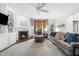 Cozy living room featuring a fireplace, built-in shelving, and lots of natural light at 2506 Blooming St, Raleigh, NC 27612