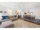 Bright living room open to dining area, showcasing hardwood floors, neutral walls, and a ceiling fan at 2506 Blooming St, Raleigh, NC 27612