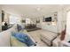 Comfortable living room with couch and open to dining room, with built-in shelving at 2506 Blooming St, Raleigh, NC 27612