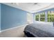 Bedroom featuring a tray ceiling, plush carpet, and an open ensuite bathroom at 2506 Blooming St, Raleigh, NC 27612