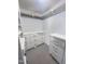 Walk-in closet with wood clothes rods and drawers at 2506 Blooming St, Raleigh, NC 27612