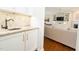 Convenient wet bar with stone countertop, sink, and lots of storage at 2506 Blooming St, Raleigh, NC 27612