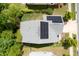Aerial view of a home with gray roof and solar panels with a well-kept lawn and mature trees at 2513 Magnolia Tree Ln, Durham, NC 27703