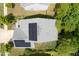 Aerial view of a gray roof with solar panels installed with a gray and green lawn that is well maintained at 2513 Magnolia Tree Ln, Durham, NC 27703