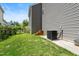 Backyard featuring a well-maintained lawn and cooling equipment, enhances outdoor living at 2513 Magnolia Tree Ln, Durham, NC 27703