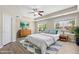 Staged bedroom with a large bed, modern furnishings, and two windows overlooking the neighborhood at 2513 Magnolia Tree Ln, Durham, NC 27703