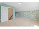 A bedroom with floral wallpaper and mint walls with angled ceilings and neutral carpets at 2513 Magnolia Tree Ln, Durham, NC 27703