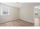 Bright, empty bedroom with a window offering ample natural light and clean, neutral walls at 2513 Magnolia Tree Ln, Durham, NC 27703