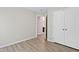 A neutral bedroom featuring modern vinyl floors and a double door closet for ample storage at 2513 Magnolia Tree Ln, Durham, NC 27703
