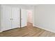 A bedroom with neutral tones, features vinyl floors, and a closet, offers serene space at 2513 Magnolia Tree Ln, Durham, NC 27703