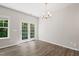 Bright dining room with hardwood floors, modern lighting, and patio door at 2513 Magnolia Tree Ln, Durham, NC 27703