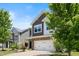 Charming two-story home featuring a stone-accented facade, two-car garage, and a beautifully landscaped front yard at 2513 Magnolia Tree Ln, Durham, NC 27703