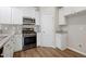Modern kitchen boasts stainless steel appliances, granite countertops, and white cabinetry at 2513 Magnolia Tree Ln, Durham, NC 27703