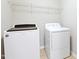 A laundry room featuring modern appliances, including a front-load washer and dryer at 2513 Magnolia Tree Ln, Durham, NC 27703