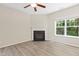 Bright living room with a cozy fireplace, ceiling fan, and wood-look flooring throughout at 2513 Magnolia Tree Ln, Durham, NC 27703