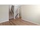 Open living space with staircase and hardwood style flooring and neutral paint throughout at 2513 Magnolia Tree Ln, Durham, NC 27703