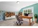 Office features a desk, rolling chair, and bookshelves at 2513 Magnolia Tree Ln, Durham, NC 27703